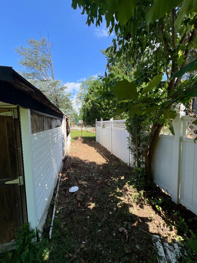Back yard strip cleared out along a fence