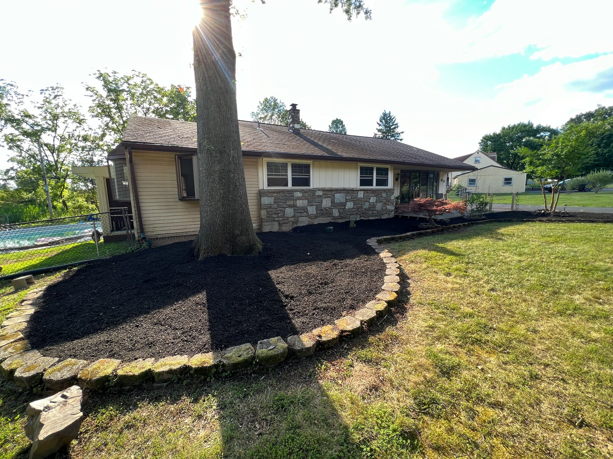 Freshly installed mulch bed along property edge