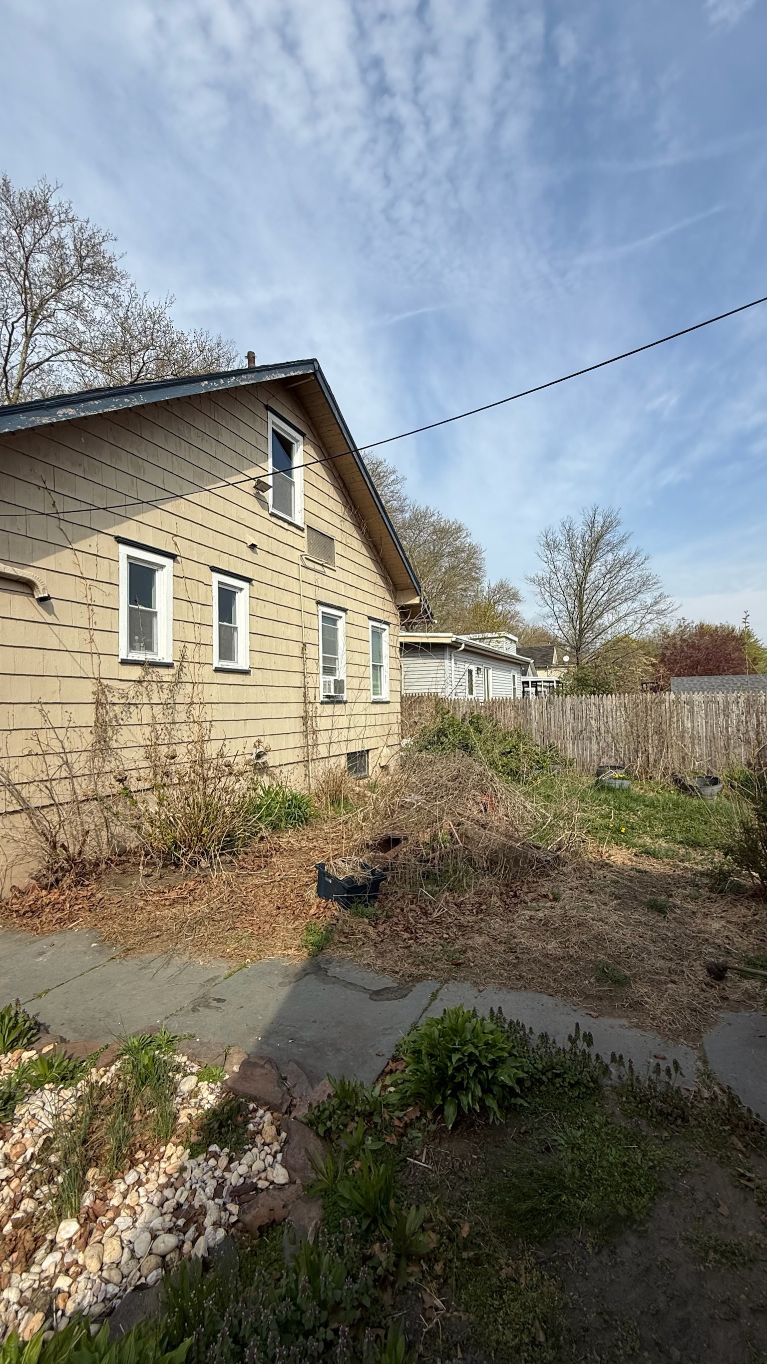 Yard cluttered with debris before seasonal cleanup